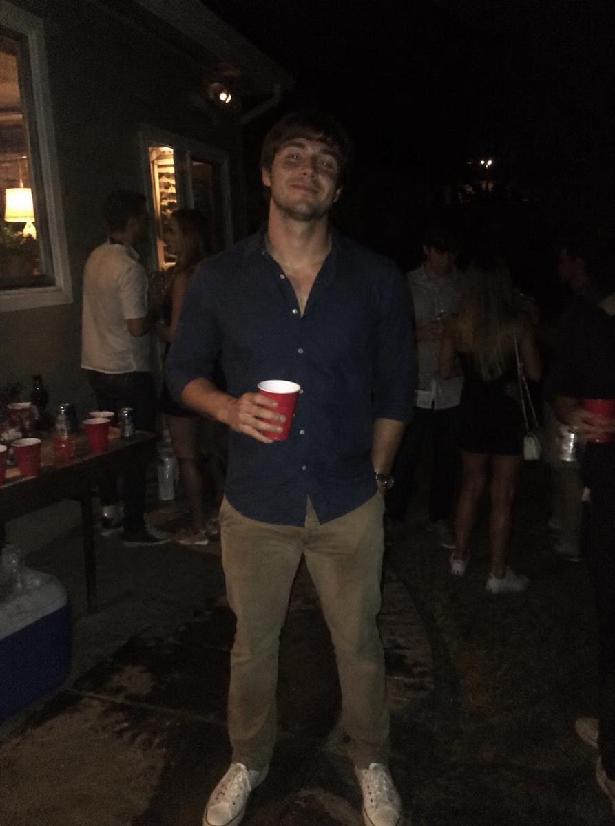 Dark, grainy night-time photo of a man