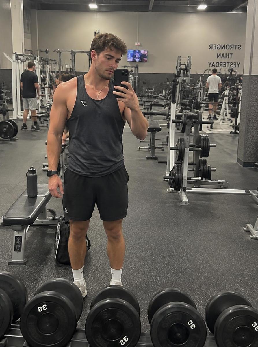 Gym mirror selfie in a vest