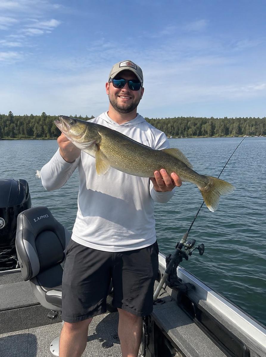 Man holding a fish on a boat